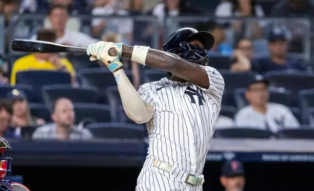 New York Yankees' Jazz Chisholm Jr. hits a sacrifice fly, scoring Ben Rice, in the third inning during the second baseball game of a doubleheader against the Boston Red Sox, Saturday, Aug. 29, 2026, in New York. (AP Photo/Corey Sipkin)