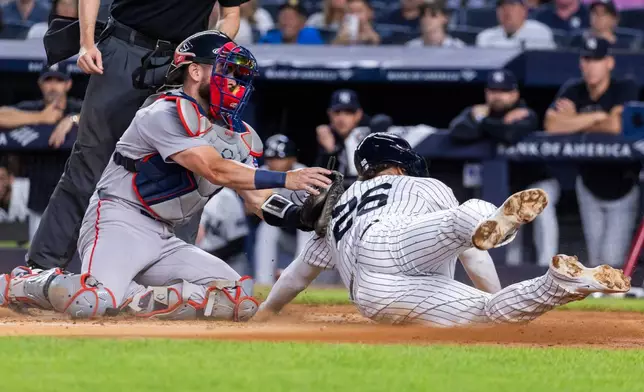 Boston Red Sox catcher Connor Wong, left, tags out New York Yankees' Luis García Jr. (26) after Spencer Jones hit into a fielder's choice in the second inning during the second baseball game of a doubleheader, Saturday, Aug. 29, 2026, in New York. (AP Photo/Corey Sipkin)