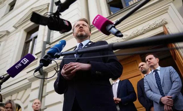 Yabloko party leader Nikolai Rybakov speaks to his supporters and journalists after hearing an appeal on a lawsuit to bar the party from the upcoming parliamentary elections, at the Russia's Supreme Court, in Moscow, Monday, Aug. 17, 2026. (AP Photo/Pavel Bednyakov)