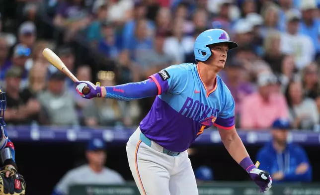 Colorado Rockies' TJ Rumfield follows the flight of his RBI single off Kansas City Royals starting pitcher Michael Wacha in the first inning of a baseball game Friday, July 31, 2026, in Denver. (AP Photo/David Zalubowski)