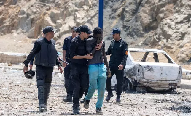 Moroccan security forces detain a man attempting to cross from the Moroccan northern town of Fnideq to the Spanish enclave of Ceuta, Friday, July 31, 2026. (AP Photo)