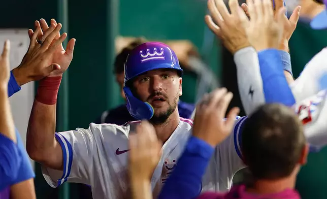 Kansas City Royals' Vinnie Pasquantino celebrates in the dugout after scoring off a Michael Massey single during the fourth inning of a baseball game against the Detroit Tigers in Kansas City, Mo., Friday, Aug. 21, 2026. (AP Photo/Colin E. Braley)