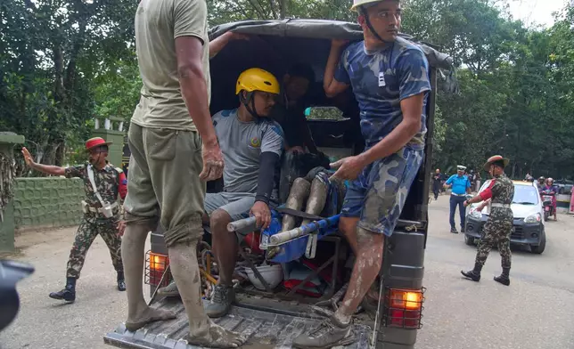 Rescuers transport the body of a flash flood victim in a truck to a hospital in Nepal's Nuwakot district, Wednesday, Aug. 26, 2026. (AP Photo/Niranjan Shrestha)