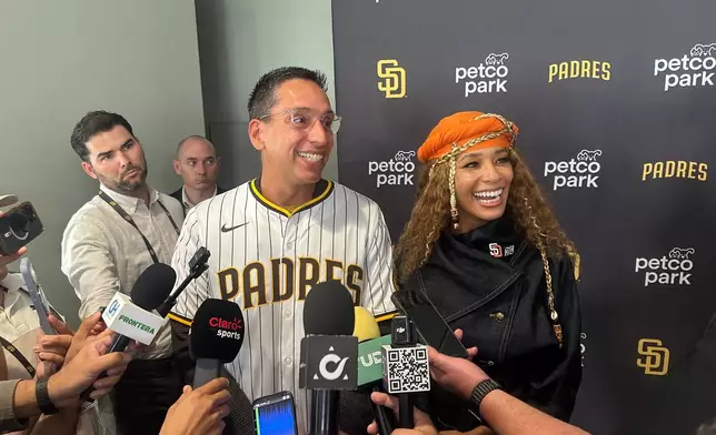 New San Diego Padres owners Kwanza Jones, right, and José E. Feliciano speak to the media at Petco Park in San Diego, Calif., Monday, Aug. 24, 2026. (AP Photo/Greg Beacham)