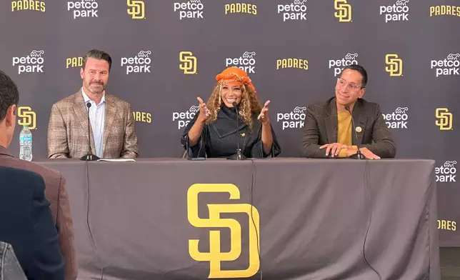 New San Diego Padres owners Kwanza Jones, center, and José E. Feliciano, right, speak at a news conference with team CEO Erik Greupner, left, at Petco Park in San Diego, Calif., Monday, Aug. 24, 2026. (AP Photo/Greg Beacham)