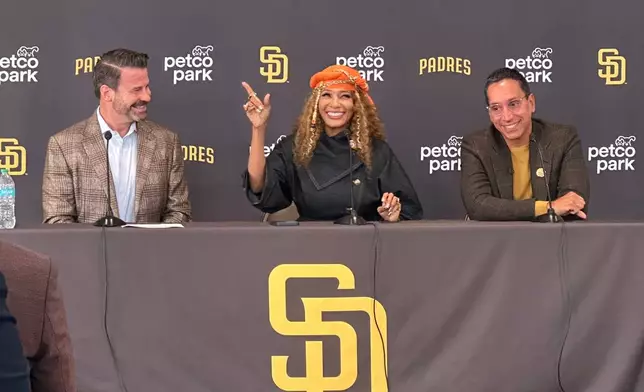 New San Diego Padres owners Kwanza Jones, center, and José E. Feliciano, right, speak at a news conference with team CEO Erik Greupner, left, at Petco Park in San Diego, Calif., Monday, Aug. 24, 2026. (AP Photo/Greg Beacham)