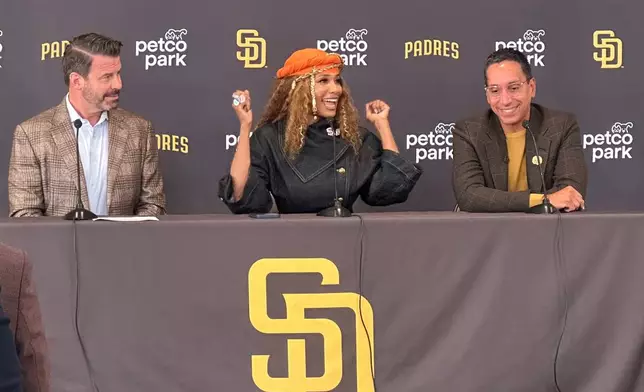 New San Diego Padres owners Kwanza Jones, center, and José E. Feliciano, right, speak at a news conference with team CEO Erik Greupner, left, at Petco Park in San Diego, Calif., Monday, Aug. 24, 2026. (AP Photo/Greg Beacham)