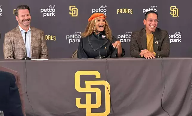 New San Diego Padres owners Kwanza Jones, center, and José E. Feliciano, right, speak at a news conference with team CEO Erik Greupner, left, at Petco Park in San Diego, Calif., Monday, Aug. 24, 2026. (AP Photo/Greg Beacham)