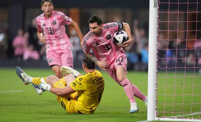 Inter Miami forward Lionel Messi (10) picks up the ball and runs after scoring his side's first goal past Atletico de San Luis goalkeeper Andres Sanchez (1) during the first half of a Leagues Cup soccer match, Wednesday, Aug. 5, 2026, in Miami. (AP Photo/Rebecca Blackwell)