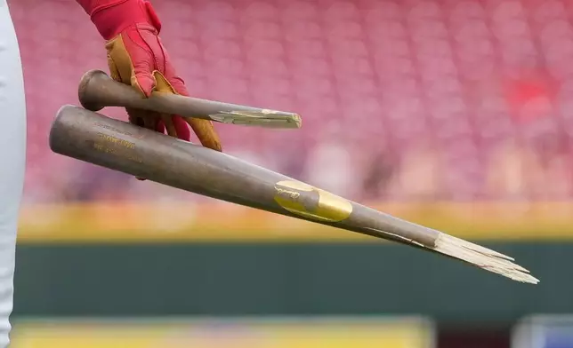 Cincinnati Reds' Dane Myers holds the bat that he broke after popping out during the third inning of a baseball game between the Cincinnati Reds and the Athletics in Cincinnati, Wednesday, Aug. 5, 2026. (AP Photo/Carolyn Kaster)