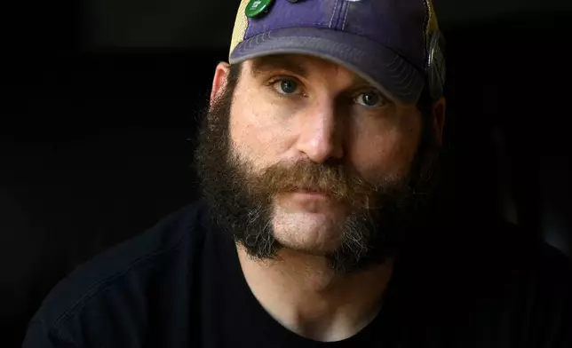 Joe Shearer, who was diagnosed with traumatic brain injuries from fighting in Iraq, poses for a portrait in his home in Colorado Springs, Colo., Wednesday, Aug. 5, 2026. (AP Photo/Thomas Peipert)