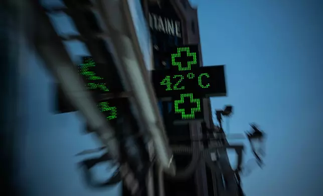 A pharmacy display shows a temperature of 42 degrees Celsius in Paris during a heat wave, Wednesday, July 29, 2026. (AP Photo/Aurelien Morissard).