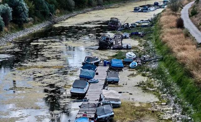 Boats are stranded in a side arm of the river Rhine that is running out of water in Mackenheim near Mainz, Germany Monday, Aug. 10, 2026. (AP Photo/Michael Probst)