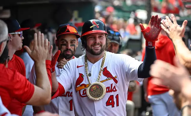 St. Louis Cardinals' Alec Burleson (41) is congratulated after hitting a solo home run in the fifth inning of a baseball game against the Colorado Rockies, Sunday, Aug. 9, 2026, in St. Louis. (AP Photo/Joe Puetz)