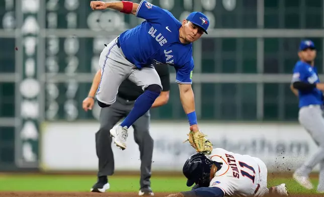 Toronto Blue Jays second baseman Luis Urías tags out Houston Astros right fielder Cam Smith (11) at second base during the eighth inning of a baseball game in Houston, Wednesday, Aug. 5, 2026. (AP Photo/Ashley Landis)