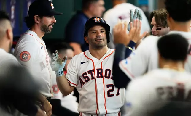Houston Astros' Jose Altuve celebrates after hitting a home run during the third inning of a baseball game against the Toronto Blue Jays in Houston, Wednesday, Aug. 5, 2026. (AP Photo/Ashley Landis)