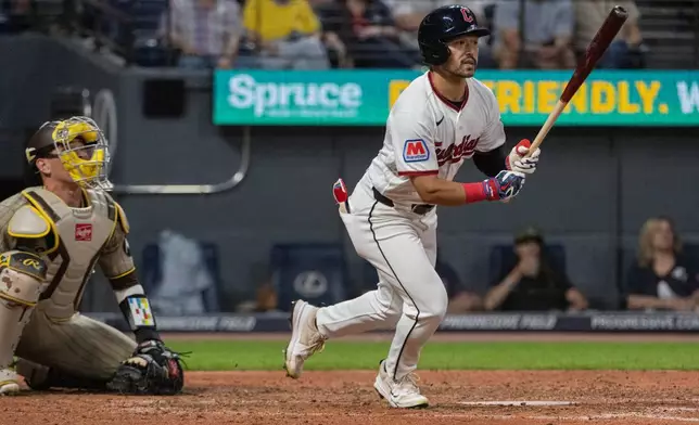 Cleveland Guardians' Steven Kwan watches his RBI double off San Diego Padres starting pitcher Randy Vasquez as catcher Freddy Fermin looks on during the fifth inning of a baseball game, Saturday, Aug. 15, 2026, in Cleveland. (AP Photo/Phil Long)