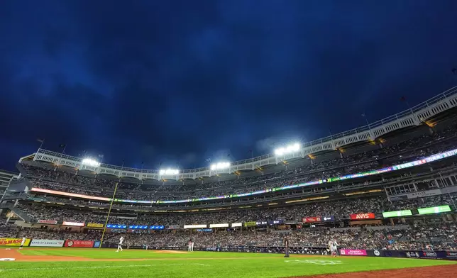 Play is stopped after lights lost power during the first inning of a baseball game between the New York Yankees and the St. Louis Cardinals Wednesday, Aug. 5, 2026, in New York. (AP Photo/Frank Franklin II)