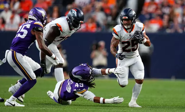 Denver Broncos running back Cody Schrader (25) runs from Minnesota Vikings outside linebacker Cam'Ron Stewart (49) during the first half of a preseason NFL football game, Friday, Aug. 28, 2026, in Denver. (AP Photo/Jack Dempsey)