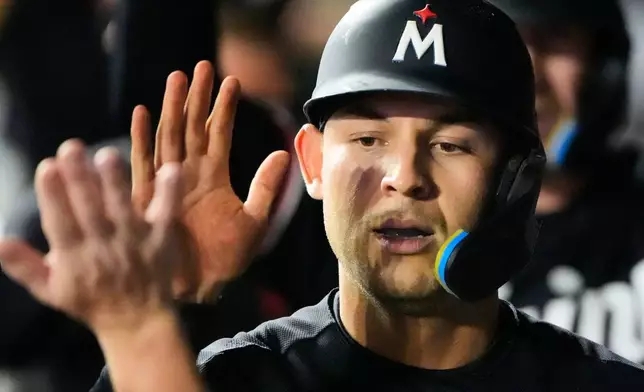 Minnesota Twins' Alex Jackson celebrates in the dugout after scoring on a two-run single by Brooks Lee during the eighth inning of a baseball game against the Kansas City Royals, Thursday, Aug. 6, 2026, in Kansas City, Mo. (AP Photo/Charlie Riedel)