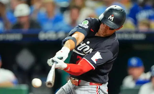 Minnesota Twins' Brooks Lee hits a two-run single during the eighth inning of a baseball game against the Kansas City Royals, Thursday, Aug. 6, 2026, in Kansas City, Mo. (AP Photo/Charlie Riedel)