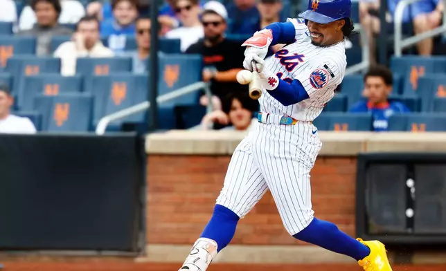 New York Mets' Francisco Lindor hits a home run against the Houston Astros during the first inning of a baseball game, Sunday, Aug. 30, 2026, in New York. (AP Photo/Noah K. Murray)