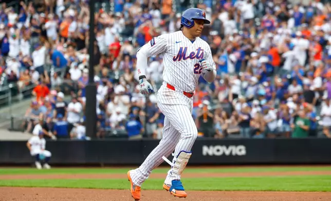 New York Mets' Juan Soto runs the bases after hitting a home run against the Houston Astros during the first inning of a baseball game, Sunday, Aug. 30, 2026, in New York. (AP Photo/Noah K. Murray)