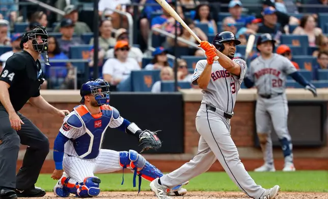 Houston Astros left fielder LaMonte Wade Jr. follows through on a home run during the sixth inning of a baseball game against the New York Mets, Sunday, Aug. 30, 2026, in New York. (AP Photo/Noah K. Murray)