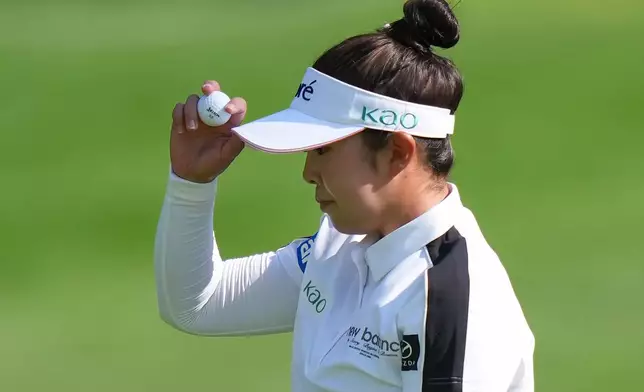 Miyu Yamashita, of Japan, tips her visor to the crowd after making birdie on the 10th hole during the second round at the LPGA Canadian Women's Open golf tournament in Edmonton, Alberta, Friday, Aug. 21, 2026. (Darryl Dyck/The Canadian Press via AP)
