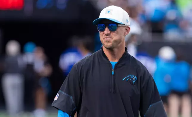 Carolina Panthers offensive coordinator Brad Idzik looks on during the NFL football team's fan fest Friday, July 31, 2026, in Charlotte, N.C. (AP Photo/Scott Kinser)