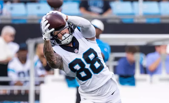 Carolina Panthers wide receiver Casey Washington makes a catch during the NFL football team's fan fest Friday, July 31, 2026, in Charlotte, N.C. (AP Photo/Scott Kinser)