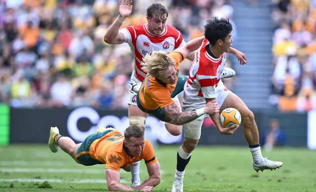 Japan's Haruto Kida is tackled by defenders during a rugby international between Japan and Australia in Townsville, Australia, Saturday, Aug.15, 2026. (Matt Taylor/AAPImage via AP)