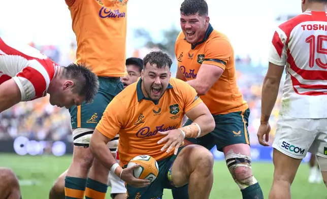 Australia's Massimo De Lutiis celebrates after scoring a try during a rugby international between Japan and Australia in Townsville, Australia, Saturday, Aug.15, 2026. (Matt TaylorAAPImage via AP)