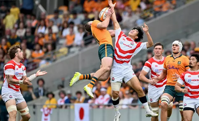 Harry Potter of Australia competes with Yoshitaka Yazaki of Japan for the ball during a rugby international between Japan and Australia in Townsville, Australia, Saturday, Aug. 15, 2026. (Dave Hunt/AAPImage via AP)