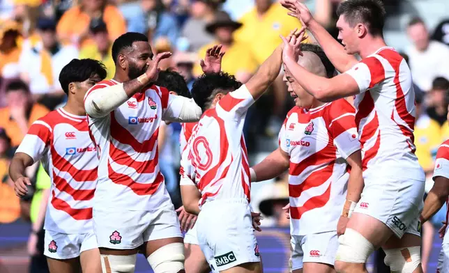 Japan's Harry Hockings, right, is congratulated by teammates after scoring a tryduring a rugby international between Japan and Australia in Townsville, Australia, Saturday, Aug.15, 2026. (Matt Taylor/AAPImage via AP)