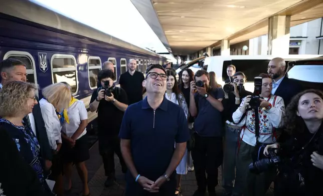 Britain's prime minister Andy Burnham, centre, smiles upon his arrival by train, in Kyiv, Monday, Aug. 24, 2026. (Henry Nicholls/Pool Photo via AP)