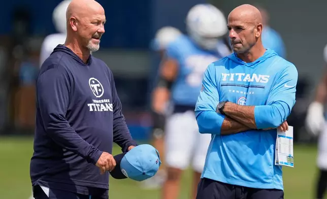 Tennessee Titans defensive coordinator Gus Bradley, left, talks to head coach Robert Saleh, right, during the NFL football team's training camp Tuesday, Aug. 4, 2026, in Nashville, Tenn. (AP Photo/George Walker IV)