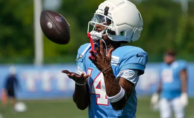 Tennessee Titans wide receiver Carnell Tate (14) makes a catch during the NFL football team's training camp Tuesday, Aug. 4, 2026, in Nashville, Tenn. (AP Photo/George Walker IV)