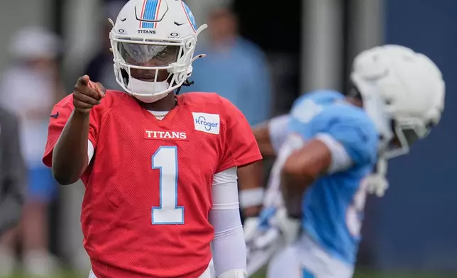 Tennessee Titans quarterback Cam Ward (1) points to a teammate during the NFL football team's training camp Tuesday, Aug. 4, 2026, in Nashville, Tenn. (AP Photo/George Walker IV)
