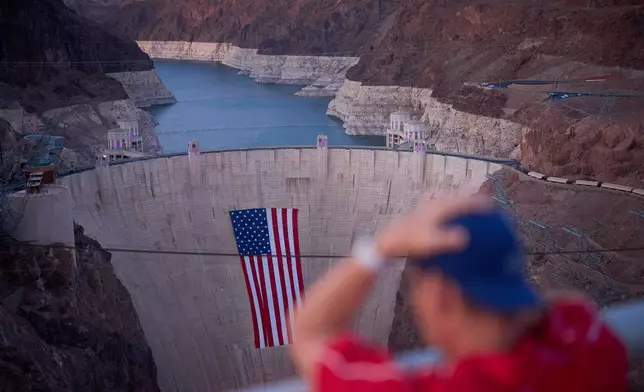 A bathtub ring of light minerals shows the high water line of Lake Mead near the Hoover Dam at the Lake Mead National Recreation Area Tuesday, June 30, 2026, near Boulder City, Nev. (AP Photo/John Locher)
