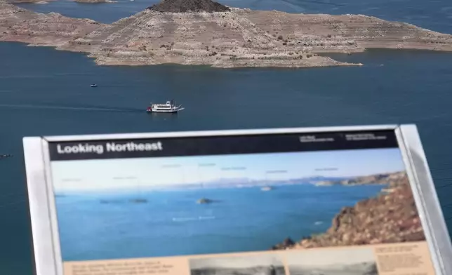 A paddle boat goes past a once nearly submerged island in Lake Mead near Boulder City, Nev., on Friday, Aug. 7, 2026. (AP Photo/Ty ONeil)
