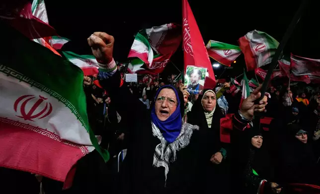 A pro-government demonstrator chants slogan during a gathering in a square in Tehran, Wednesday, Aug. 26, 2026. (AP Photo/Vahid Salemi)