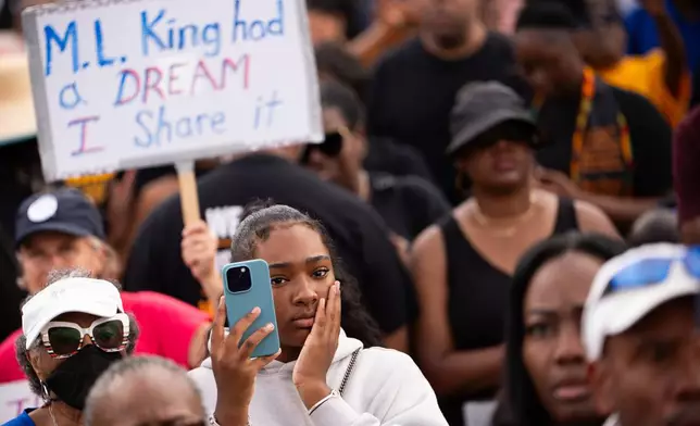 Demonstrators listen to speakers during the March on Washington, Friday, Aug. 28, 2026, near the Lincoln Memorial in Washington. (AP Photo/Julia Demaree Nikhinson)