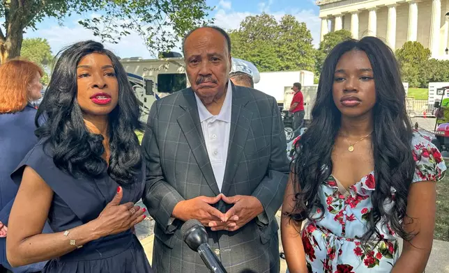 Arndrea Waters King, from left, Martin Luther King III and their daughter Yolanda Renee King participate in an interview before the March on Washington, Friday, Aug. 28, 2026, near the Lincoln Memorial in Washington. (AP Photo/Nathan Ellgren)