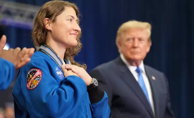 Artemis II crew member Christina Koch reacts after President Donald Trump, right, presented her with the Congressional Space Medal of Honor, Friday, Aug. 28, 2026, at Johnson Space Center in Houston. (AP Photo/Mark Schiefelbein)