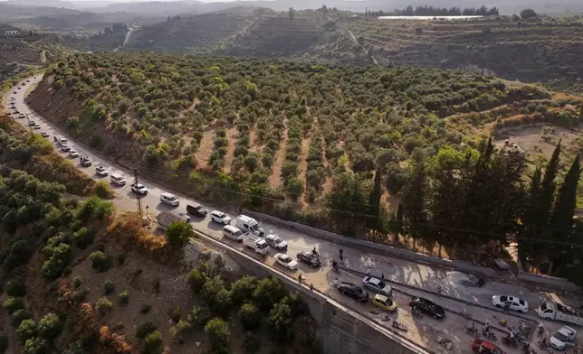 A funeral procession for Mohammad Ghamira, a former White Helmets volunteer who died shortly after his release from jail, travels through the countryside near the village of al-Haffa, in Latakia province, Syria, Monday, Aug. 17, 2026. (AP Photo)