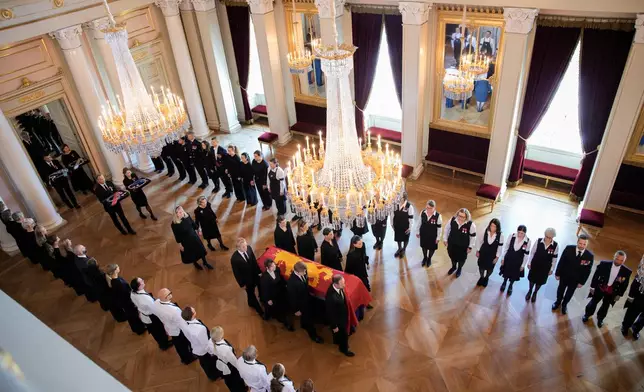 Norway's King Harald V's coffin is moved by King Harald's family and court staff from the Red Salon to the Palace Chapel in Oslo, Norway, on Monday, Aug. 31, 2026. (Stian Lysberg Solum/Pool Photo via AP)