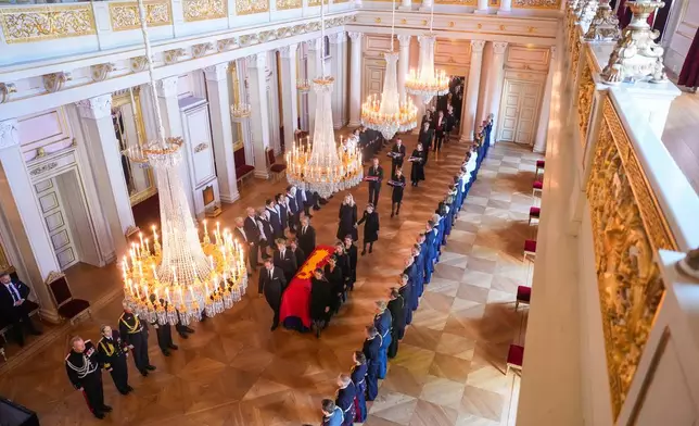 Norway's King Harald V's coffin is moved by King Harald's family and court staff from the Red Salon to the Palace Chapel in Oslo, Monday, Aug. 31, 2026. (Javad Parsa/Pool Photo via AP)