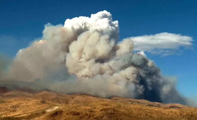 This image taken from video shows plumes of smoke rising from active wildfires Saturday, Aug. 22, 2026, in Reno, Nevada. (Tim Walton via AP)