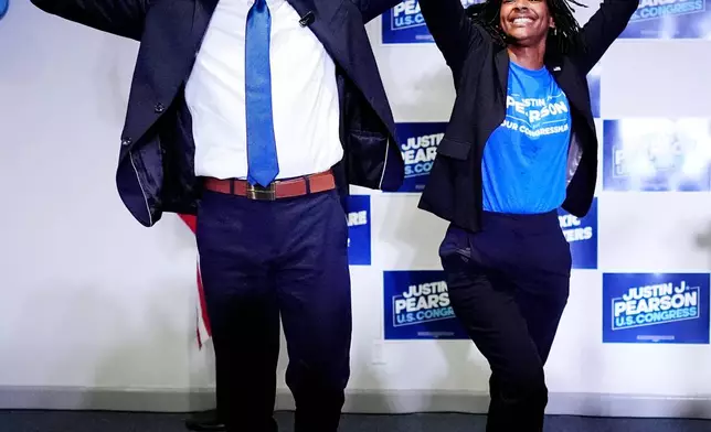 Democratic congressional candidate State Rep. Justin J. Pearson, D-Memphis, joined by his wife Oceana, greet supporters at a primary election night party, Thursday, Aug. 6, 2026, in Memphis, Tenn. (AP Photo/George Walker IV) CORRECTION: Corrects month, date and year.